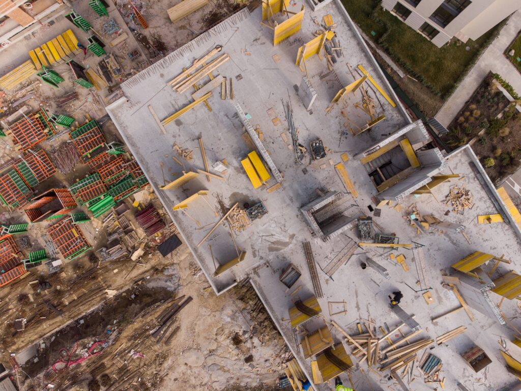Busy construction site and construction equipment aerial top view
